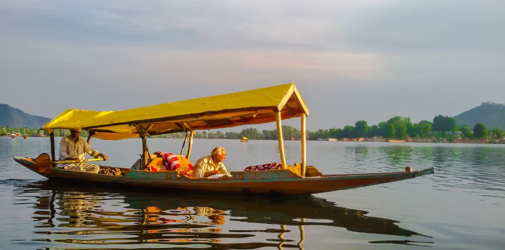 Kashmir Tour Package 4N-5D @10,999 Book Now 1 One person enjoying Shikara ride with Shikara owner in Dal Lake, Srinagar in Kashmir Tour Package.